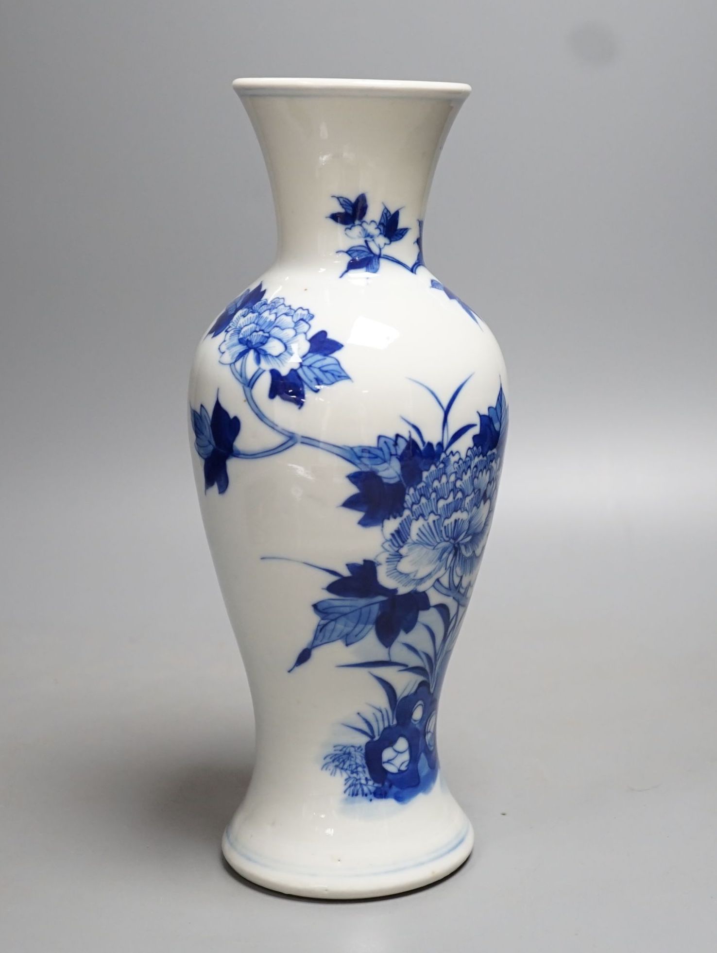 A late 19th century Chinese blue and white baluster vase, painted with birds amid flowers and rock work, pseudo Kangxi mark. 26cm